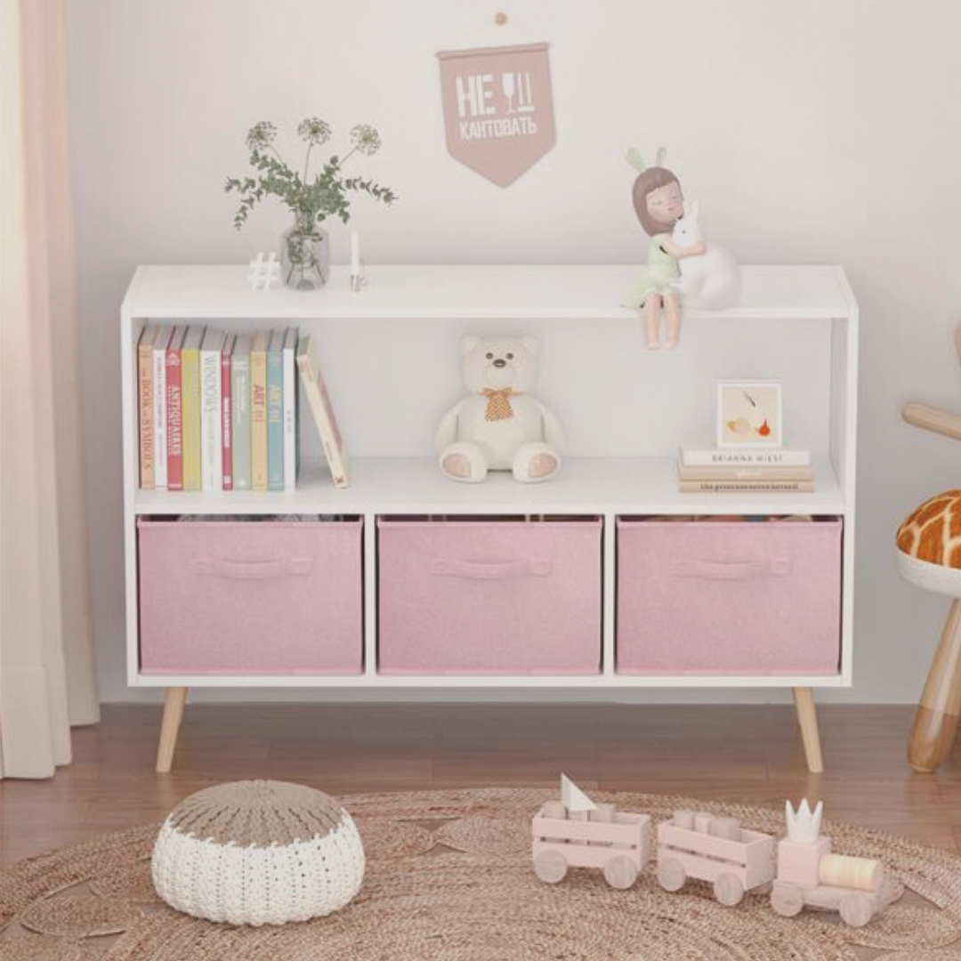 White storage unit with pink bins in a child's room