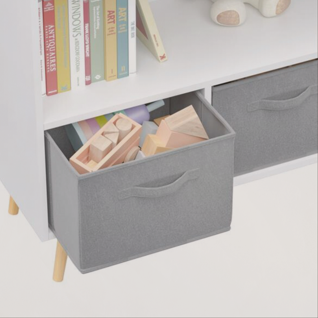 Gray storage box on a white shelf with books and wooden blocks.